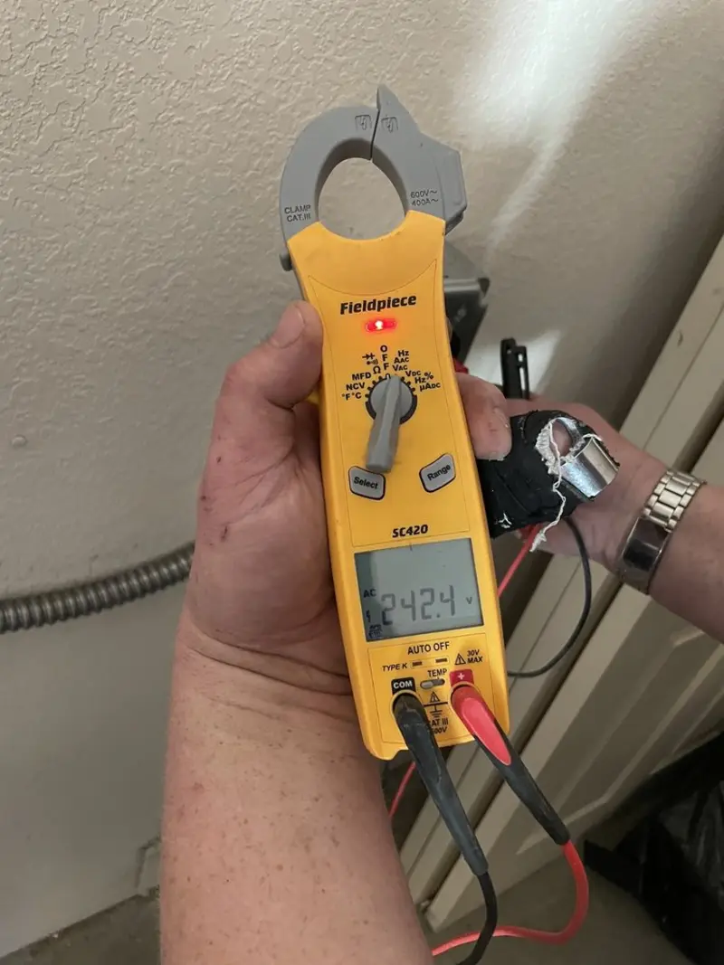Voltage testing with clamp meter during Ceiling Fan Installation in North Star